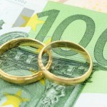 15465634-two-wedding-rings-and-money-as-symbol-f-r-an-expensive-alliance